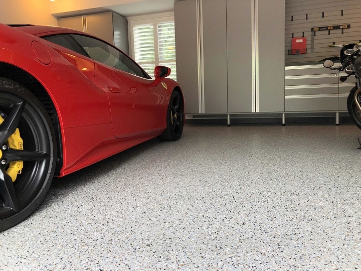 red car in garage with epoxy flooring